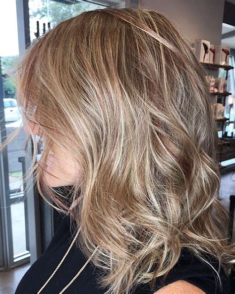 Balayage hair salon - Subtle balayage hair. Hailey Bieber wore her golden blonde balayage subtle towards the ends to brighten up her dirty blonde shade. Mixed in with slightly layered waves, it’s the perfect “I ...